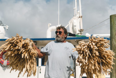 Sponge Diver with a fresh catch on the World Famous Sponge Docks. Photo by Sam Silver.